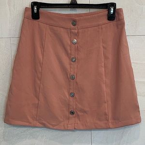 Peachy colored button up mini skirt, size medium in perfect condition